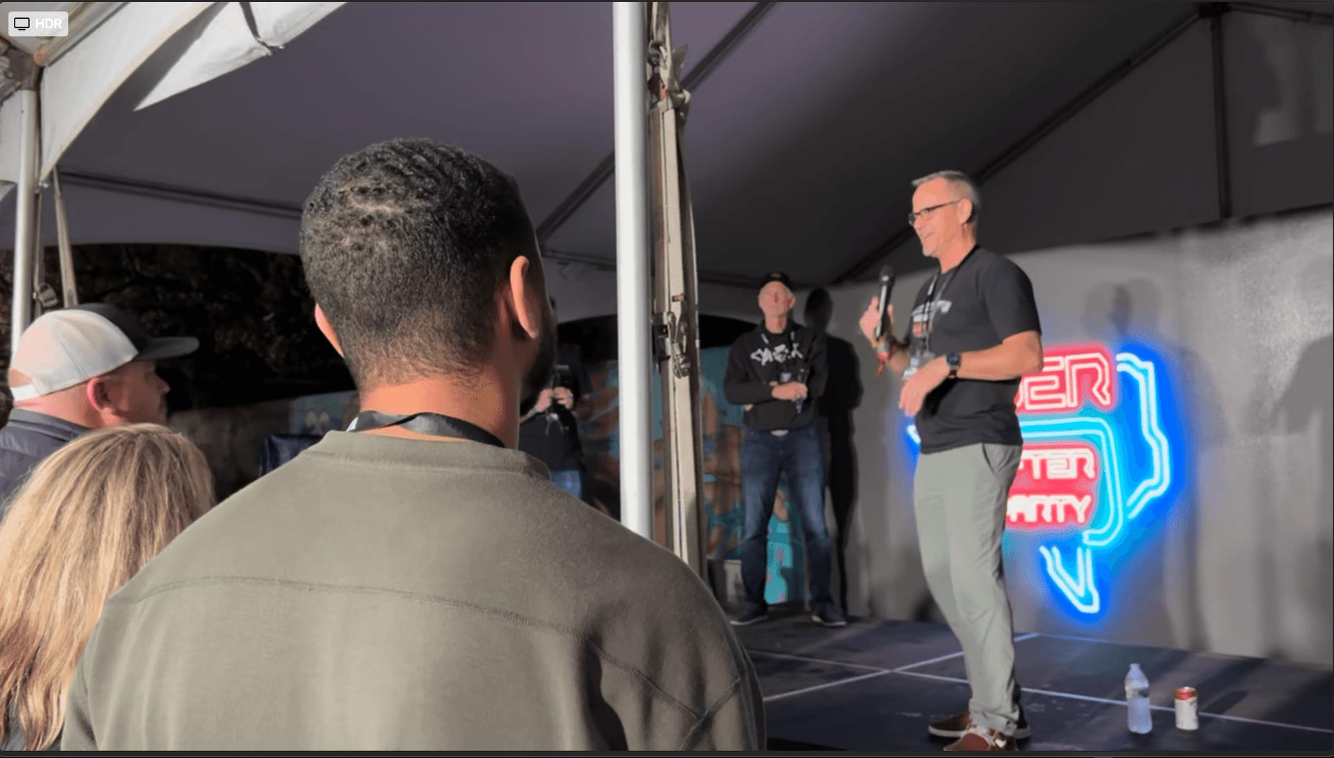 John L. Gibbs speaking with panelists after a cybersecurity event